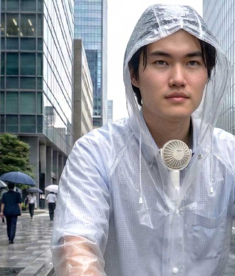 レインコート内の汗ムレを換気するエアシャツ扇風機を使用している様子